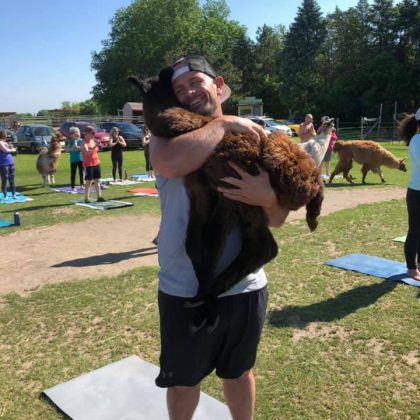 Yoga Man Hugging a Llama